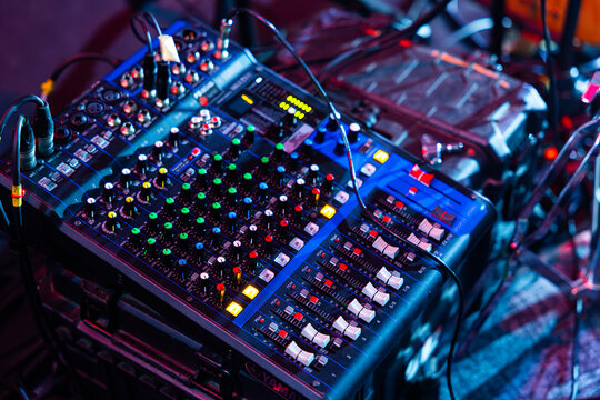 Compact Analog Audio Mixer with Connected Cables and Glowing Indicators on Stage