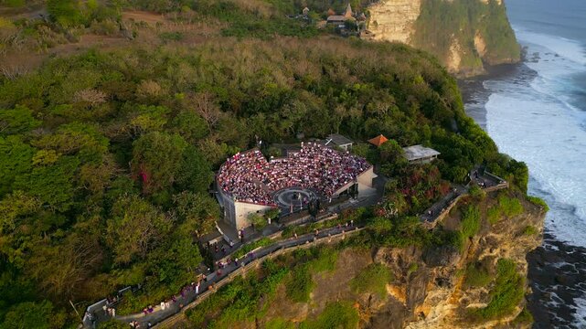 Aerial video of Kecak dance show at Uluwatu temple on cliff above ocean in Bali. High quality 4k footage