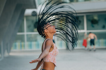 young latina woman lifting her hair in the wind