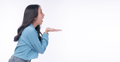 Side profile portrait of excited Asian woman looking at empty copy space open mouth and holding palms up. Surprised young female isolated on white background for advertising and product presentation. © kaew6566