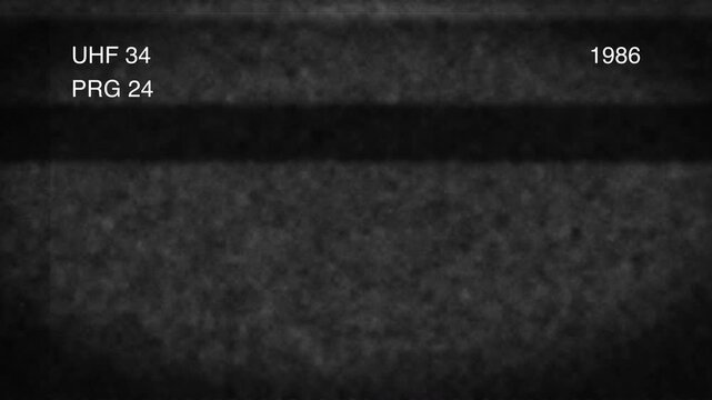 A 4K static screen displaying UHF 34 PRG 24 and 1986 on a textured black background