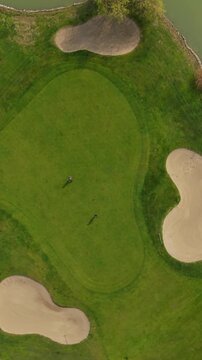 Aerial View of Golf Players on Green Fairway