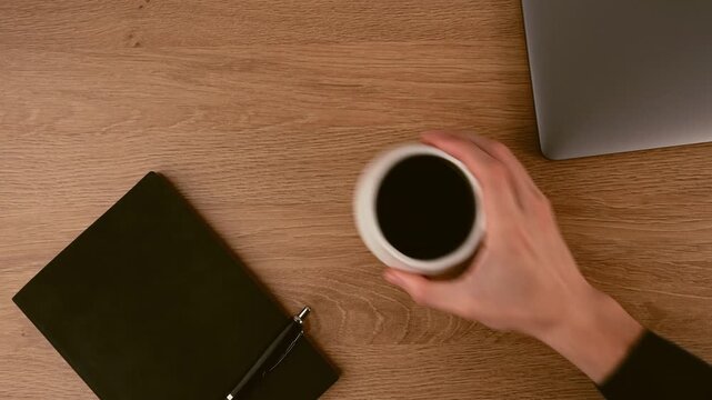 A flat lay shows a warm wooden desk setup for work or study