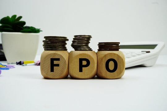 Stack of coins with wood blocks with "FPO (Follow On Public Offer)" Financial concept