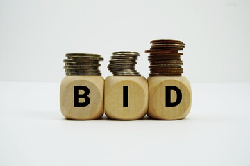Stack of coins with wood blocks with "BID" Financial concept © may1985