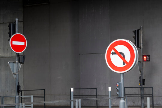 Minimal concrete wall scene with urban street traffic sign showing regulation and prohibition symbol in daylight with clean graphic message and copy space