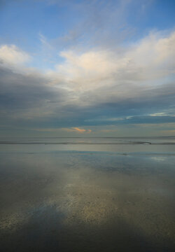 Calm Eems estuary at Delfzijl the Netherlands with dramatic sky reflection