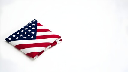 Fototapeta premium A folded American flag on a simple backdrop, representing patriotism and national pride.