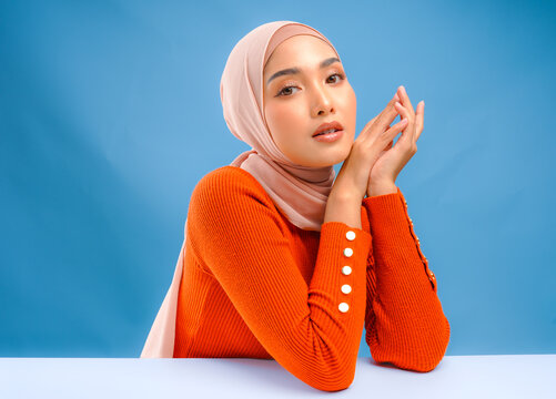 Beautiful young Asian Muslim woman with make up posing and looking to the camera.