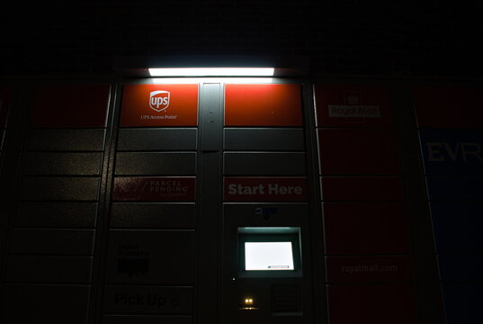 UPS parcel locker lit up at night at the Range store in Boston Lincs. UK. Feb 2026