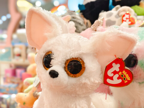 White fluffy Ty Beanie Boos plush toy with big sparkling golden eyes and red heart tag on display with other stuffed animals on February 13, 2026 in Bangkok, Thailand.