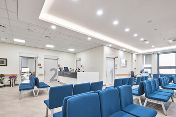Clean modern hospital or clinic interior with patient beds and medical facility lighting.