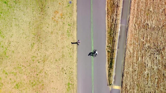 土手沿いを走る自転車を空撮　4K