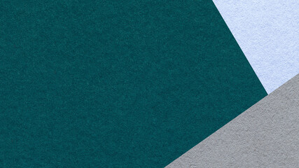 Dark emerald textured paper background with light blue gray triangular corners and copy space for presentation, banner © nikol85