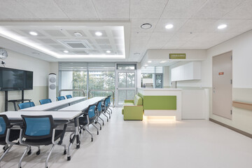 Empty modern office interior with desks, chairs, and large windows in a contemporary workspace.