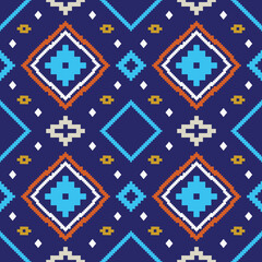 Colorful pixel style geometric ethnic seamless pattern with diamond shapes and abstract tribal elements on dark blue background. Decorative mosaic ornament design 