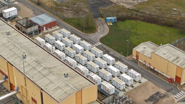 Aerial view of a neatly arranged array of white containers contrasting against the industrial landscape, Brigg, United Kingdom.