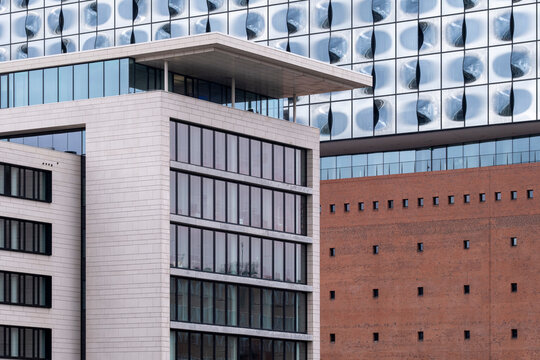 Glass and stone facade of a modern office building shows a windows pattern in Hamburg HafenCity Germany highlighting contemporary architecture design