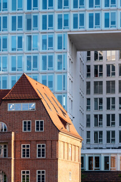 Brick heritage building contrasts with modern skyline in Hamburg HafenCity Germany showing architecture where historic character meets contemporary urban renewal