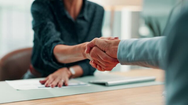 Document, people or handshake at desk in office, partnership agreement or joint venture contract. Deal, teamwork or staff shaking hands for investment project merger, meeting or profit opportunity