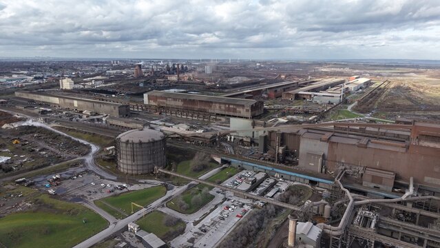 Aerial view of steel structures, sprawling industrial complex, and vast landscapes blending into the horizon, Scunthorpe, Scunthorpe, United Kingdom.