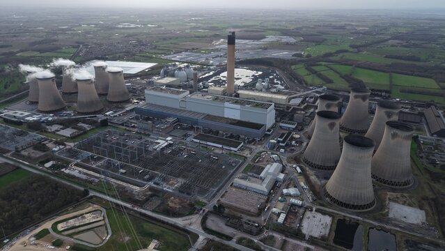 Aerial view of the industrial landscape where the cooling towers loom like giants, contrasted against the sprawling complex of Drax Power Station, Selby, United Kingdom.