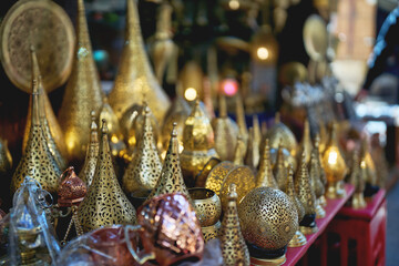 Traditional brass lanterns and Moroccan decor displayed in market stall