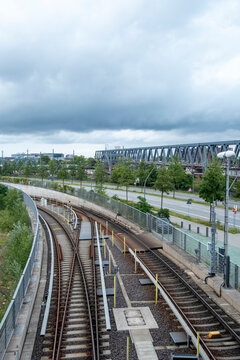 Urban transport infrastructure with curving railway tracks by station platform in Hamburg Germany showing modern rail corridor