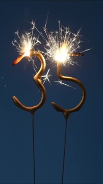 35 years celebration festive background made with Bengal fires in the form of number Thirty five. Vertical video.