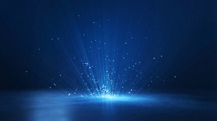 A bright burst of white and blue light erupting from a concrete floor, scattering glowing particles and volumetric rays upwards into darkness. © Satvinder