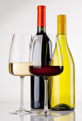 Naklejka premium Different wine bottles and glasses on white background