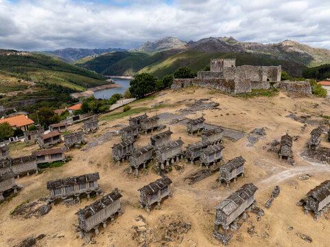 Aerial view of Espigueiros standing as silent witnesses, the castle walls echoing tales of old, against a backdrop of rolling hills and open skies, Lindoso, Viana do Castelo District, Portugal.