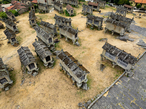 Aerial view of Espigueiros de Lindoso, stone granaries standing as silent witnesses to time, their weathered surfaces contrasting with the arid landscape, Lindoso, Viana do Castelo District, Portugal.