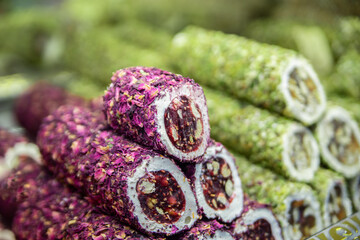 Beautiful background with confectionery red and green. National dish Turkish delight with white...