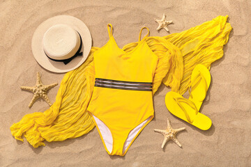 Yellow swimsuit with hat and starfishes on sand