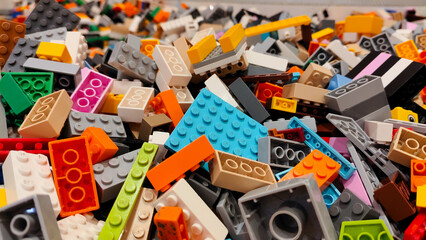 Naklejka premium High angle view of a massive pile of colorful LEGO plastic building bricks and toy blocks in various shapes and sizes on September 15, 2025 in Bangkok, Thailand.
