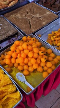 Pan right of bees landed on local Malay savory 'kueh muih' sold at local market in the Ramadhan month in Kelantan, Malaysia.Local savory normally tasted sweet and not good for diabetic. 