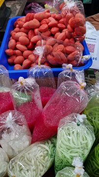 Pan up of colorful local Malay drinks &lsquo;cendol&rsquo; and sago packed in a single use plastic during the month of Ramadhan in Kelantan, Malaysia. These drinks were normally sold before breaking fast.