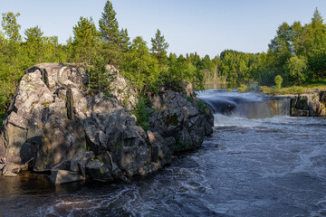 At the Voitsky Padun waterfall on a July day. Karelia, Russia