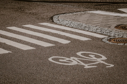Crosswalk and bikelane on road asphalt show markings for cycling urban mobility in Stockholm Sweden improving transport safety