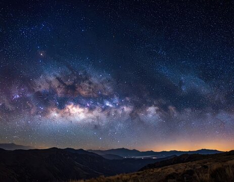 Vibrant Milky Way Galaxy Arching Over Dark Mountain Silhouettes Under a Starry Night Sky