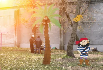 Poster Piraten Colorful pirate cartoon in a park with playful characters and a tall palm tree in autumn setting  © Vital