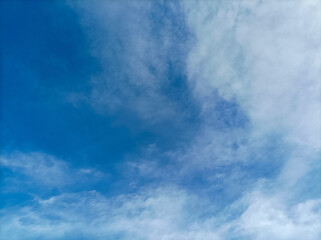 Fototapeta premium Beautiful bright blue sky with soft white clouds background.