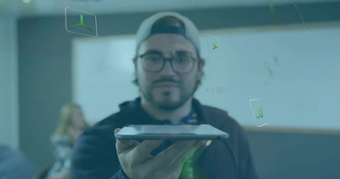 Male presenter holding tablet in tech lab, demonstrating AR with green icons rotating around tablet
