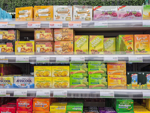 ​Variety of Indonesian herbal supplements and energy drinks on a supermarket shelf. Includes sachet drinks for health and vitality in a retail display