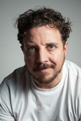 Fototapeta premium Intense Young Man with an Inquisitive and Challenging Gaze in Studio Portrait