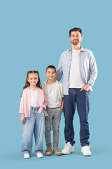 Fototapeta premium Happy father with his little children on blue background