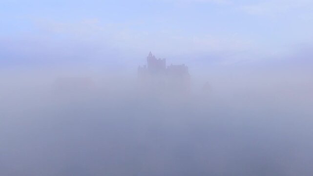 Beynac-et-Cazenac, France - 12 September 2025: Aerial view of the Chateau de Beynac shrouded in a sea of ethereal fog, creating a surreal, dreamlike landscape.