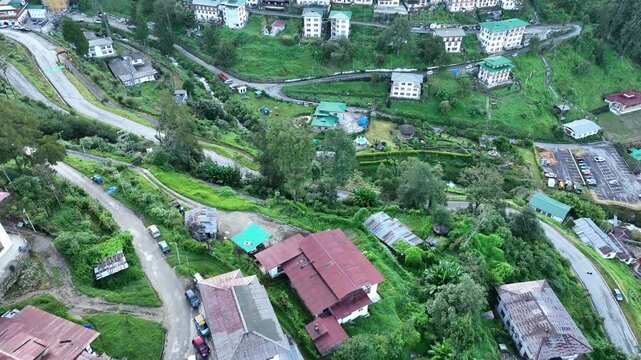 Aerial view of traditional buildings with green roofs nestled amidst lush greenery, showcasing the unique architecture, Trongsa, Trongsa, Bhutan.