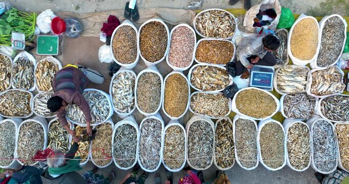 Kurigram, Bangladesh - 10 February 2026: Aerial view of a vibrant market displaying an array of dried fish in white sacks, creating a textured pattern.